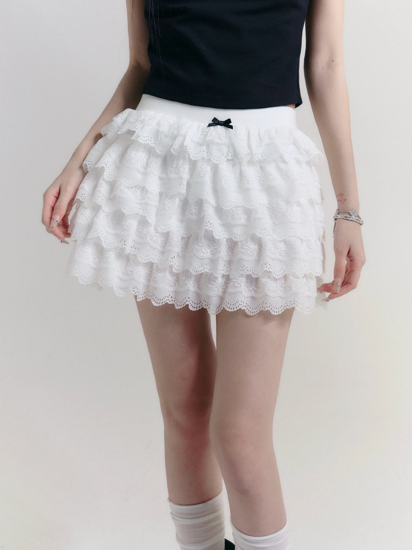 Angelic Tiers Mini Skirt: White Lace Ruffle Layers with Bow Accent